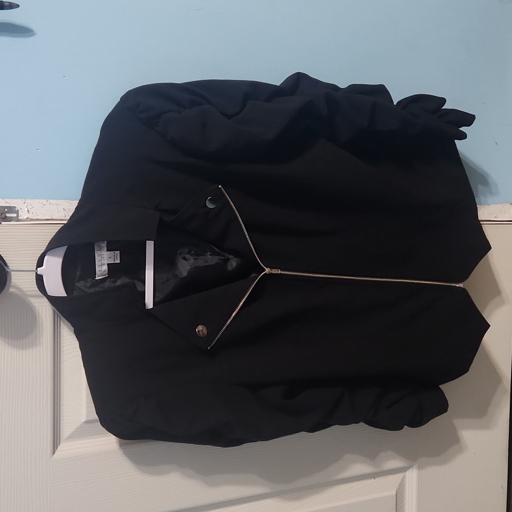 Black with silver zipper jacket, it is a Large and brand is from Stuido